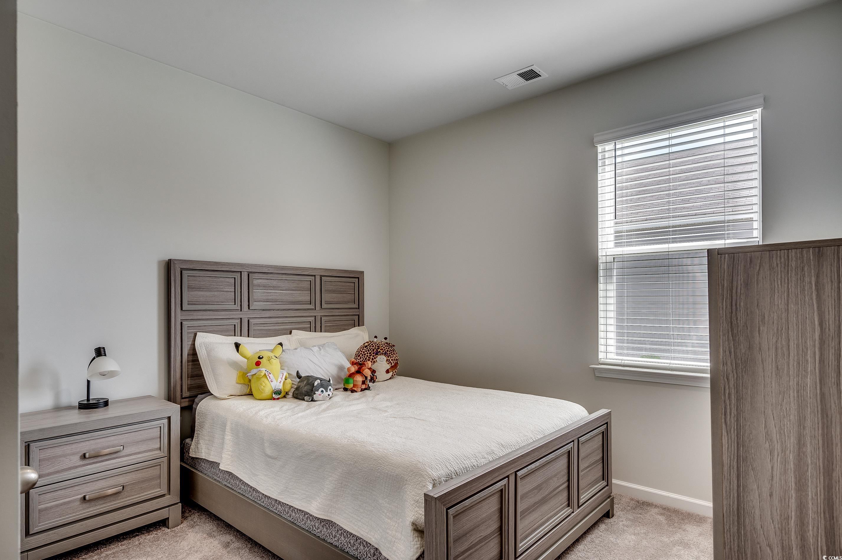 2924 Skylar Drive Myrtle Beach, SC 29577 - Photo 16 of 30 Bedroom with light colored carpet and baseboards