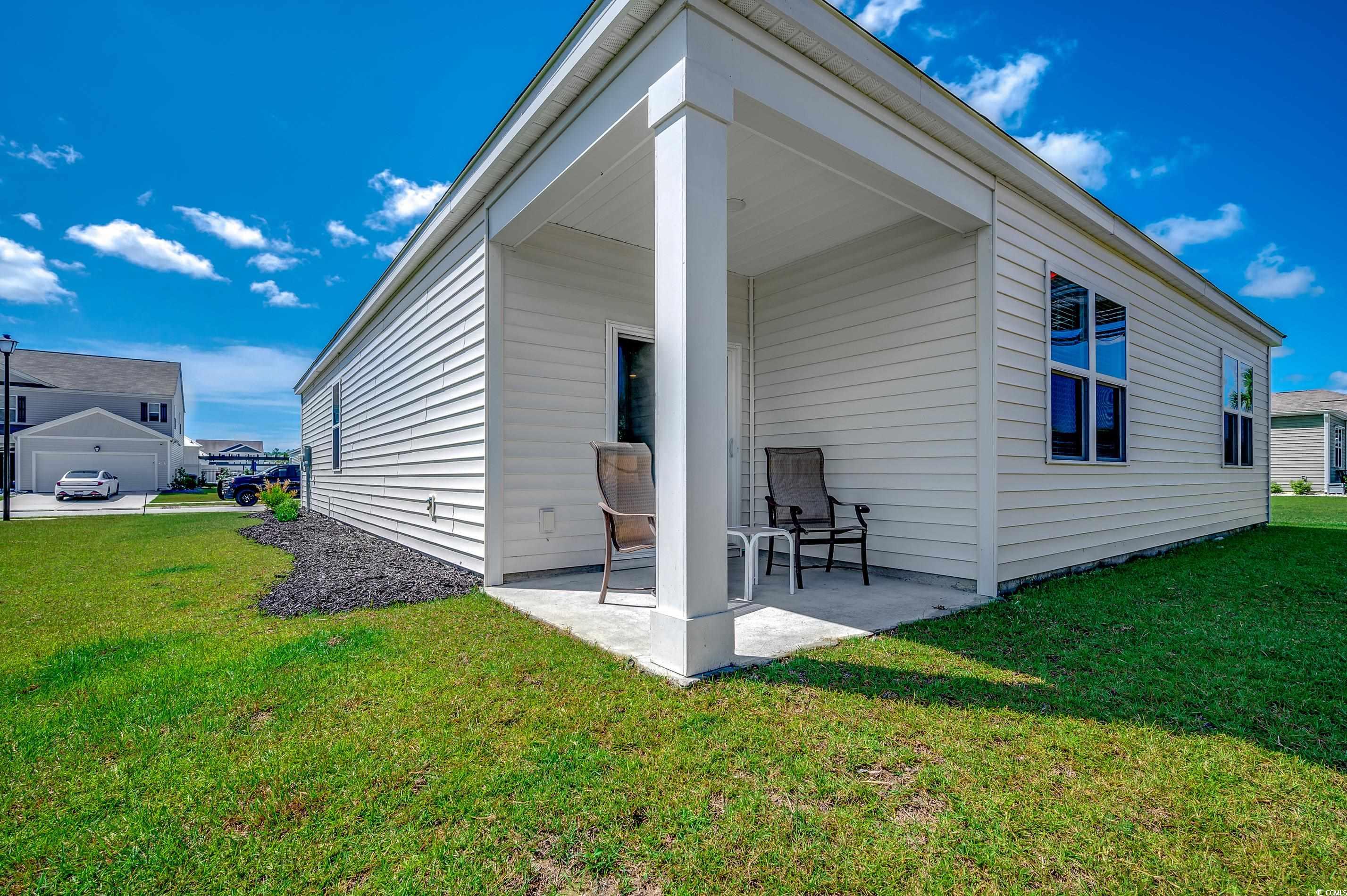 2924 Skylar Drive Myrtle Beach, SC 29577 - Photo 22 of 30 Rear view of house with a lawn and a patio
