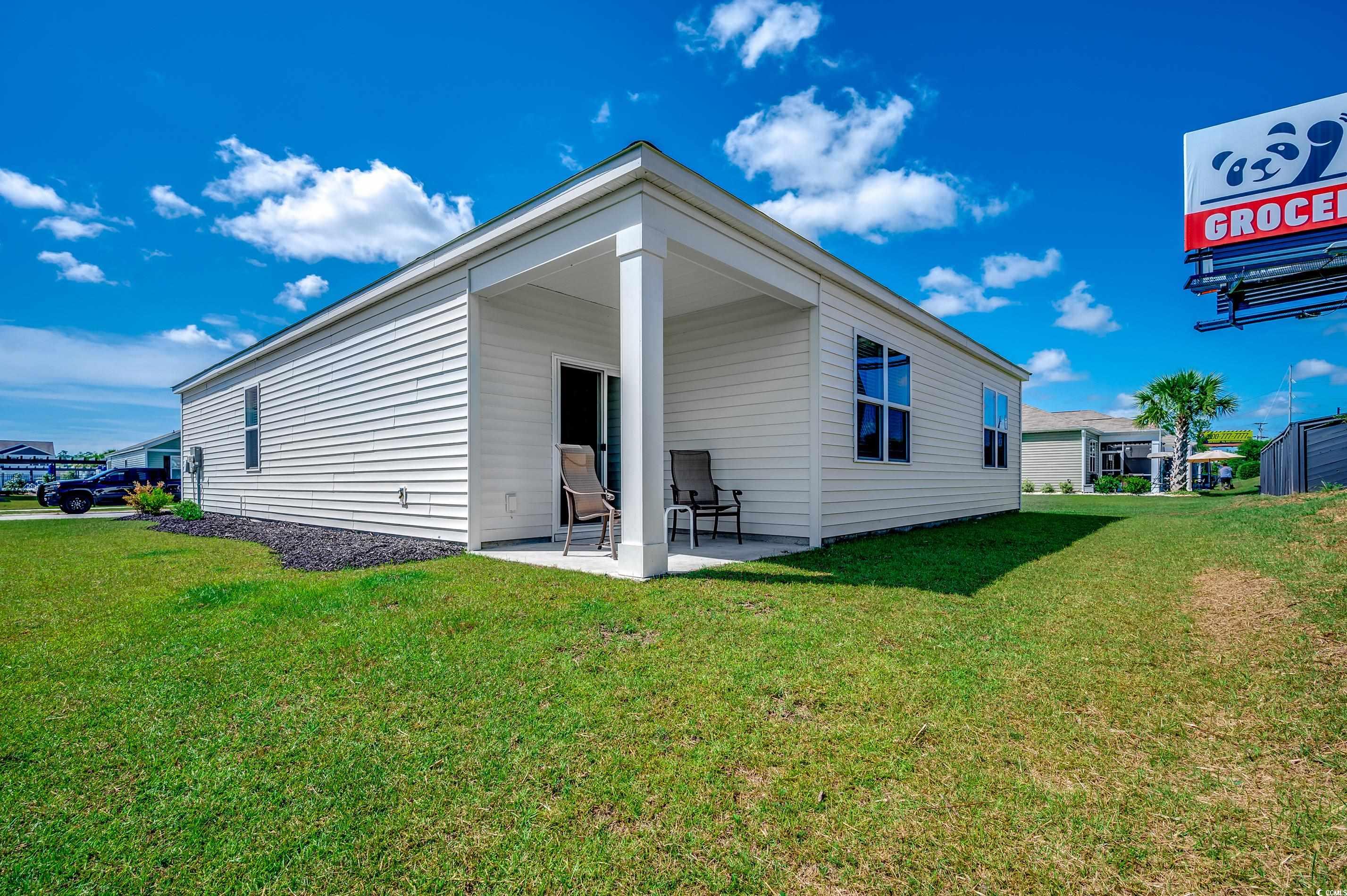 2924 Skylar Drive Myrtle Beach, SC 29577 - Photo 23 of 30 Rear view of property with a patio area and a lawn