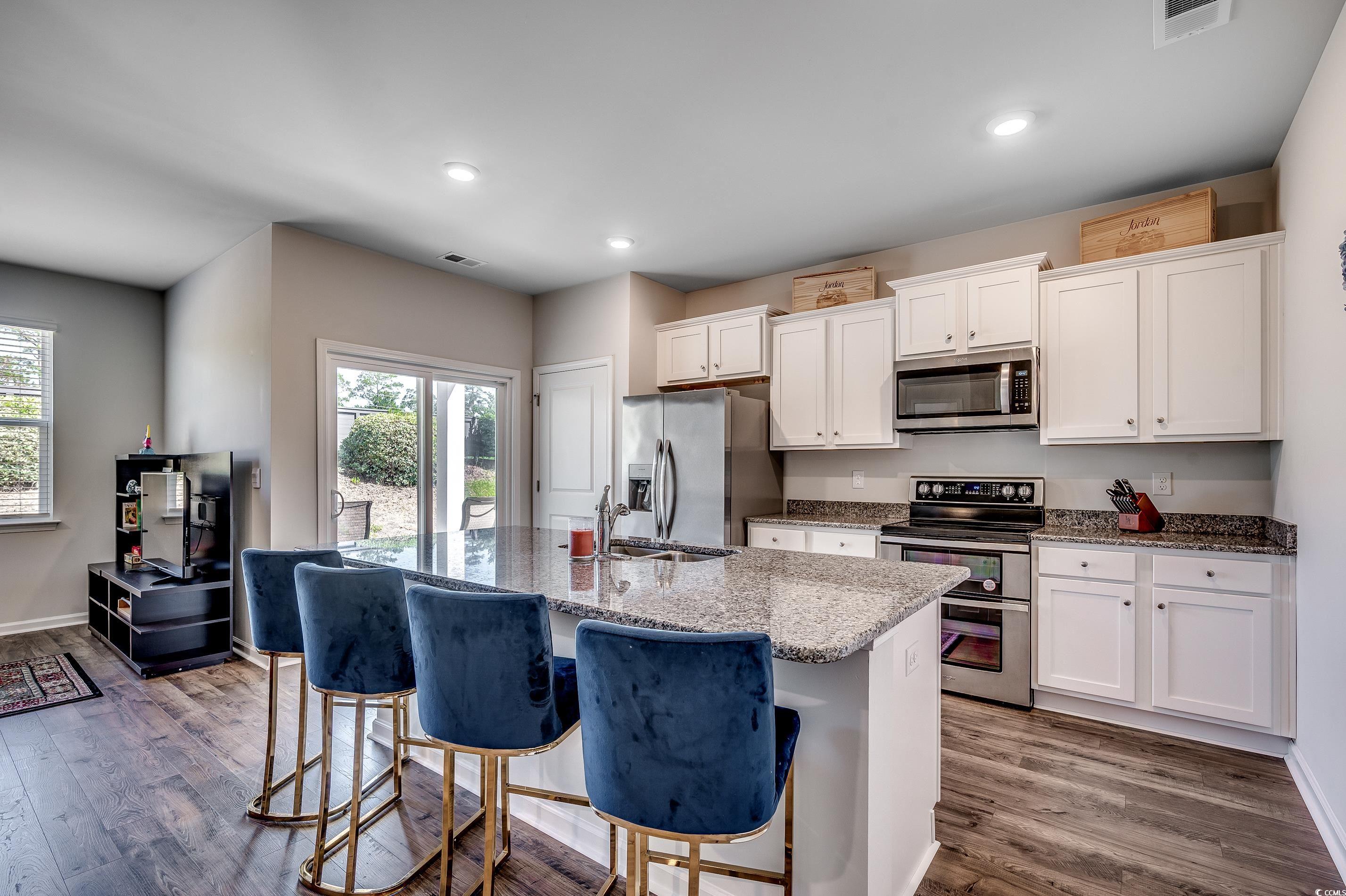 2924 Skylar Drive Myrtle Beach, SC 29577 - Photo 3 of 30 Kitchen featuring stainless steel appliances, a kitchen island with sink, white cabinets, dark wood-style floors, and recessed lighting