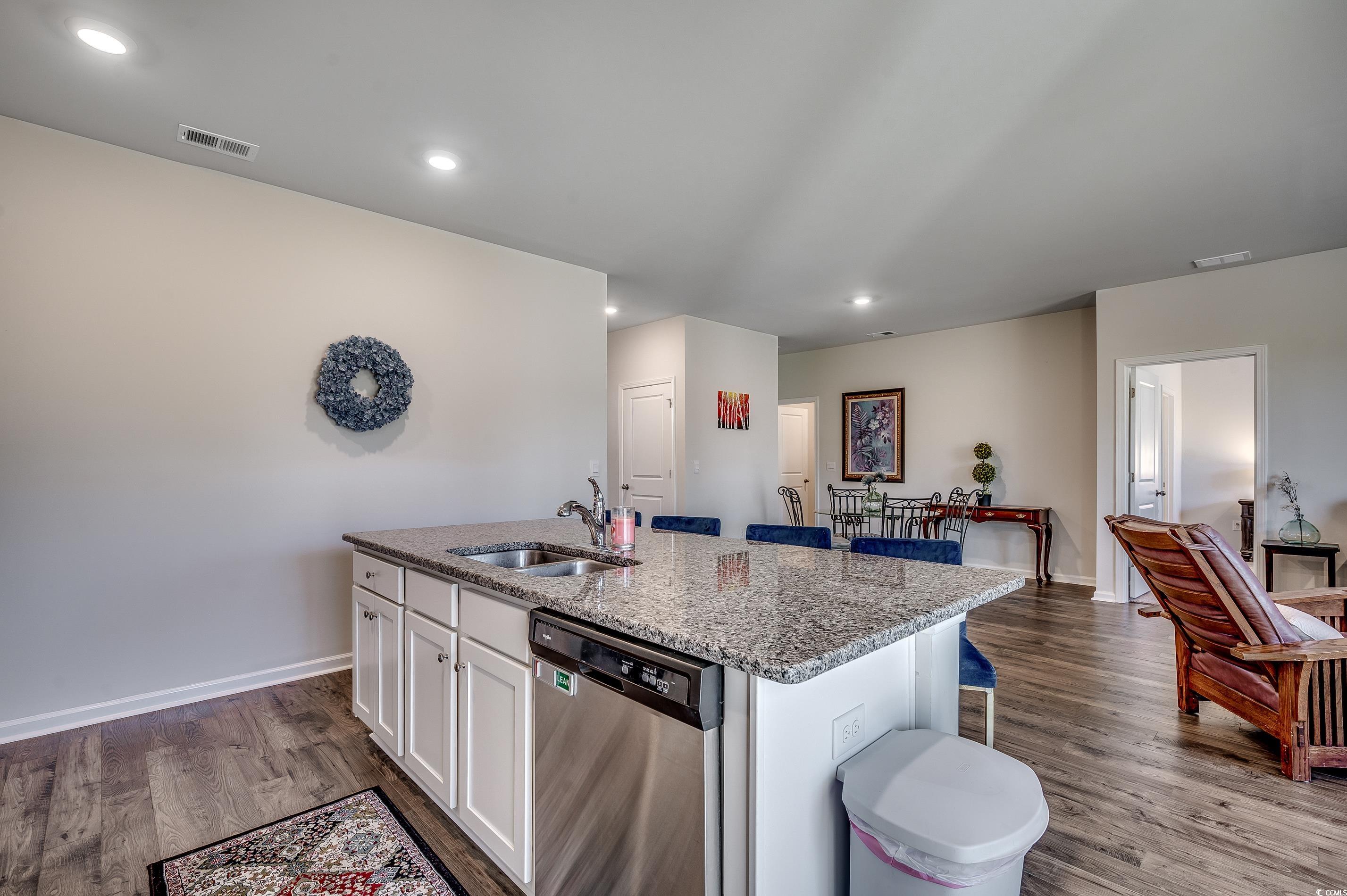 2924 Skylar Drive Myrtle Beach, SC 29577 - Photo 6 of 30 Kitchen with dishwasher, a kitchen island with sink, white cabinetry, light stone countertops, and recessed lighting