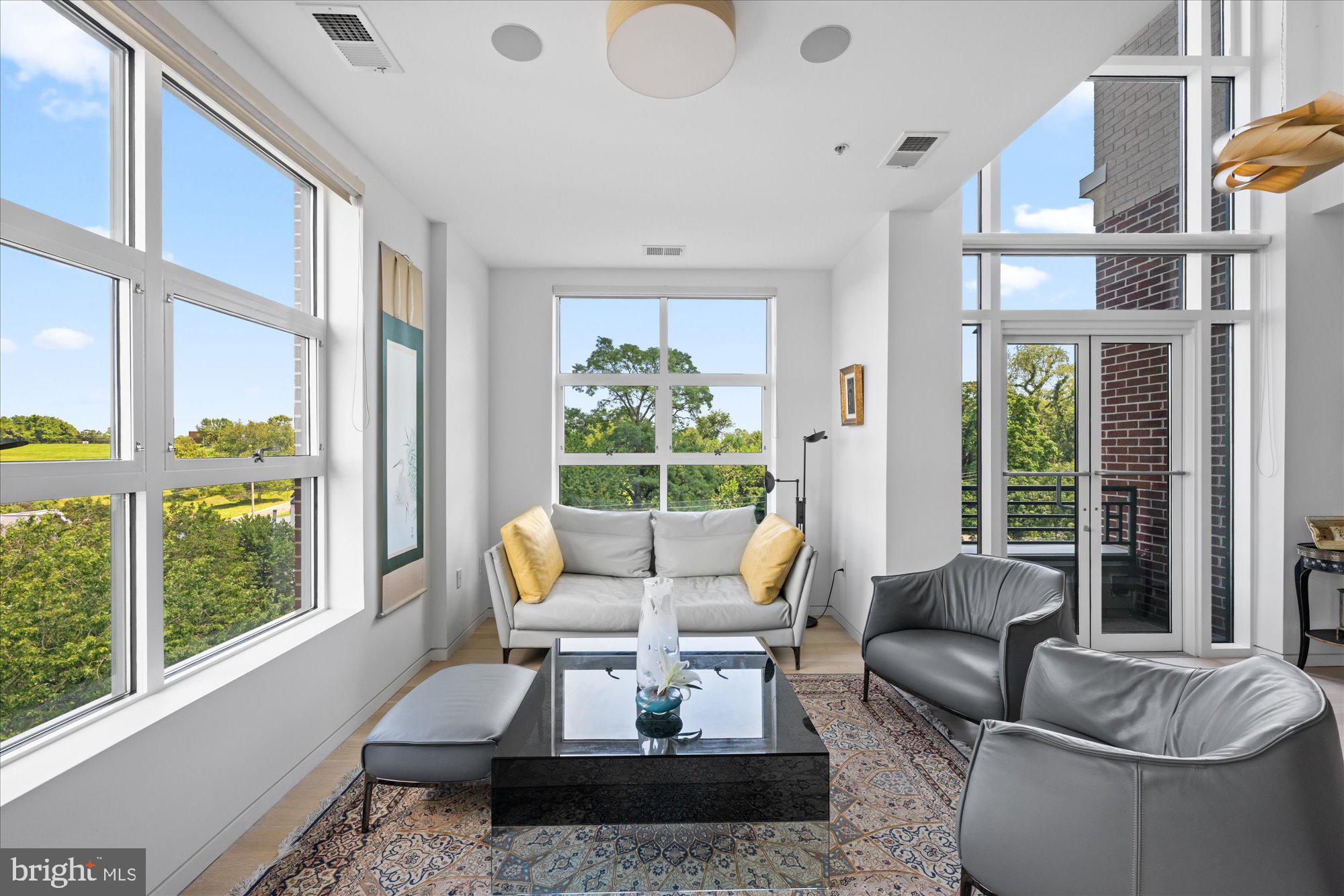4750 41st Street Northwest, Unit 507 Washington, DC 20016 - Photo 10 of 50 a living room with furniture and a large window