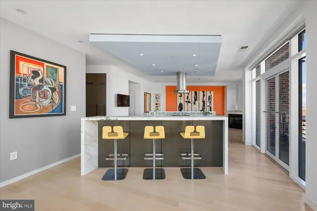 a living room with furniture a flat screen tv and large windows