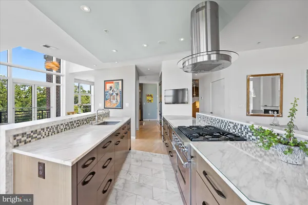 a kitchen with counter top space and wooden floor
