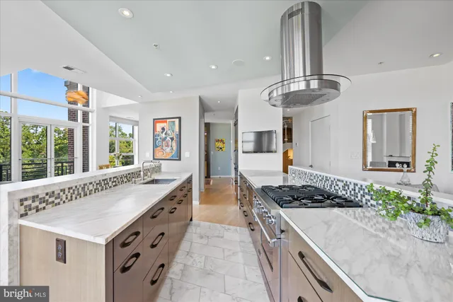 a kitchen with counter top space and wooden floor