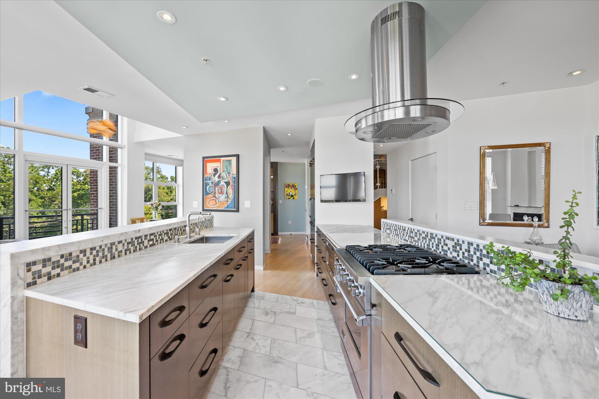 4750 41st Street Northwest, Unit 507 Washington, DC 20016 - Photo 14 of 50 a kitchen with stainless steel appliances granite countertop a stove and a sink