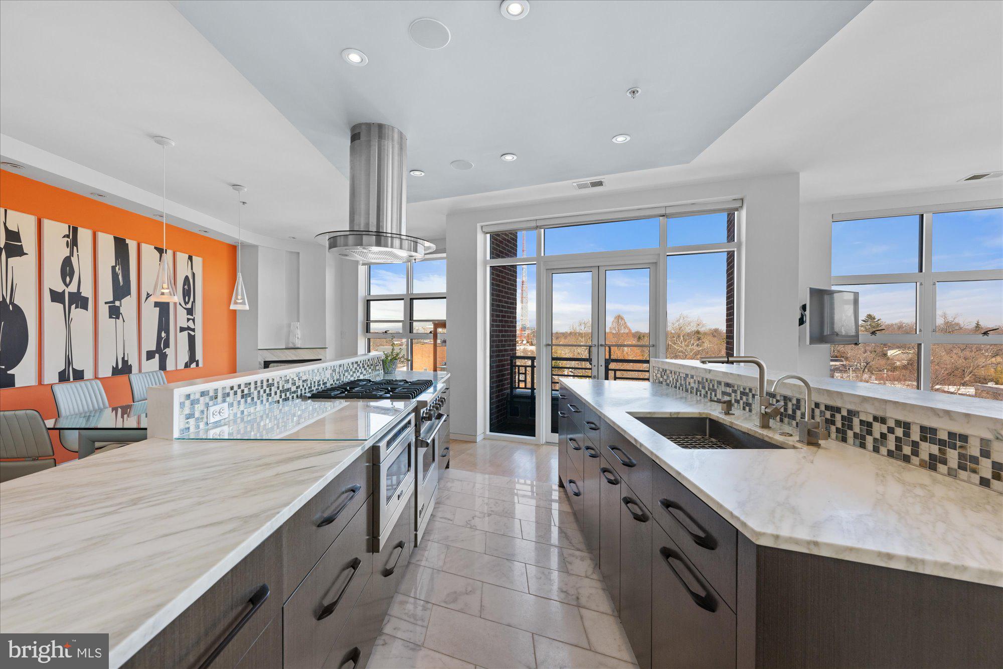 4750 41st Street Northwest, Unit 507 Washington, DC 20016 - Photo 16 of 50 an open kitchen with granite countertop a sink stove and cabinets