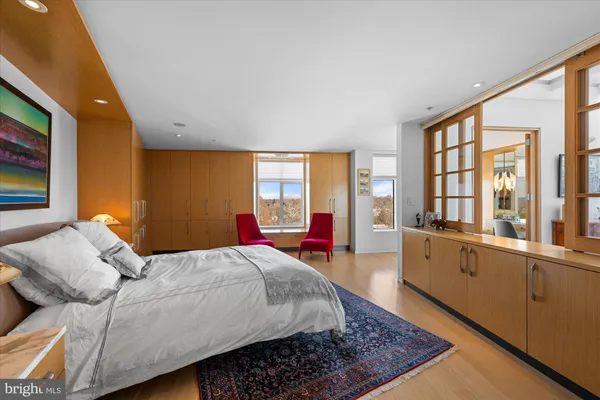 a bedroom with furniture and a large window