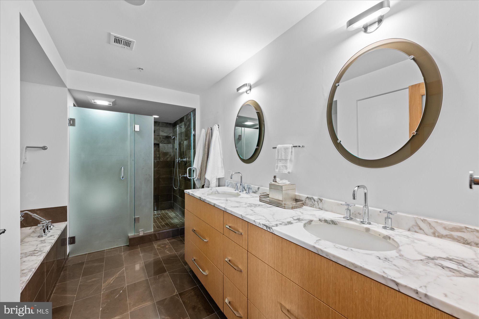 4750 41st Street Northwest, Unit 507 Washington, DC 20016 - Photo 28 of 50 a bathroom with a granite countertop double vanity sinks and a mirror