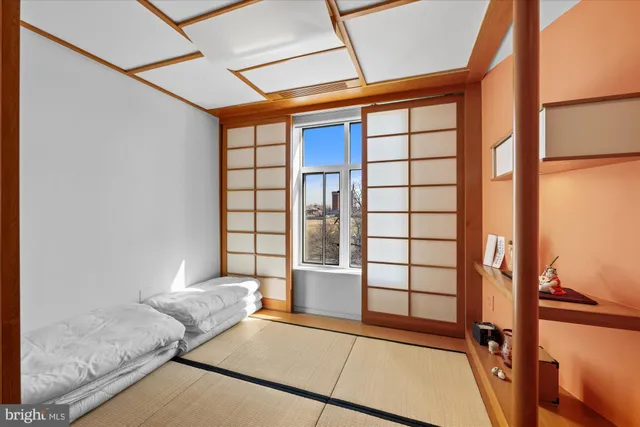 a view of front door with furniture and a window
