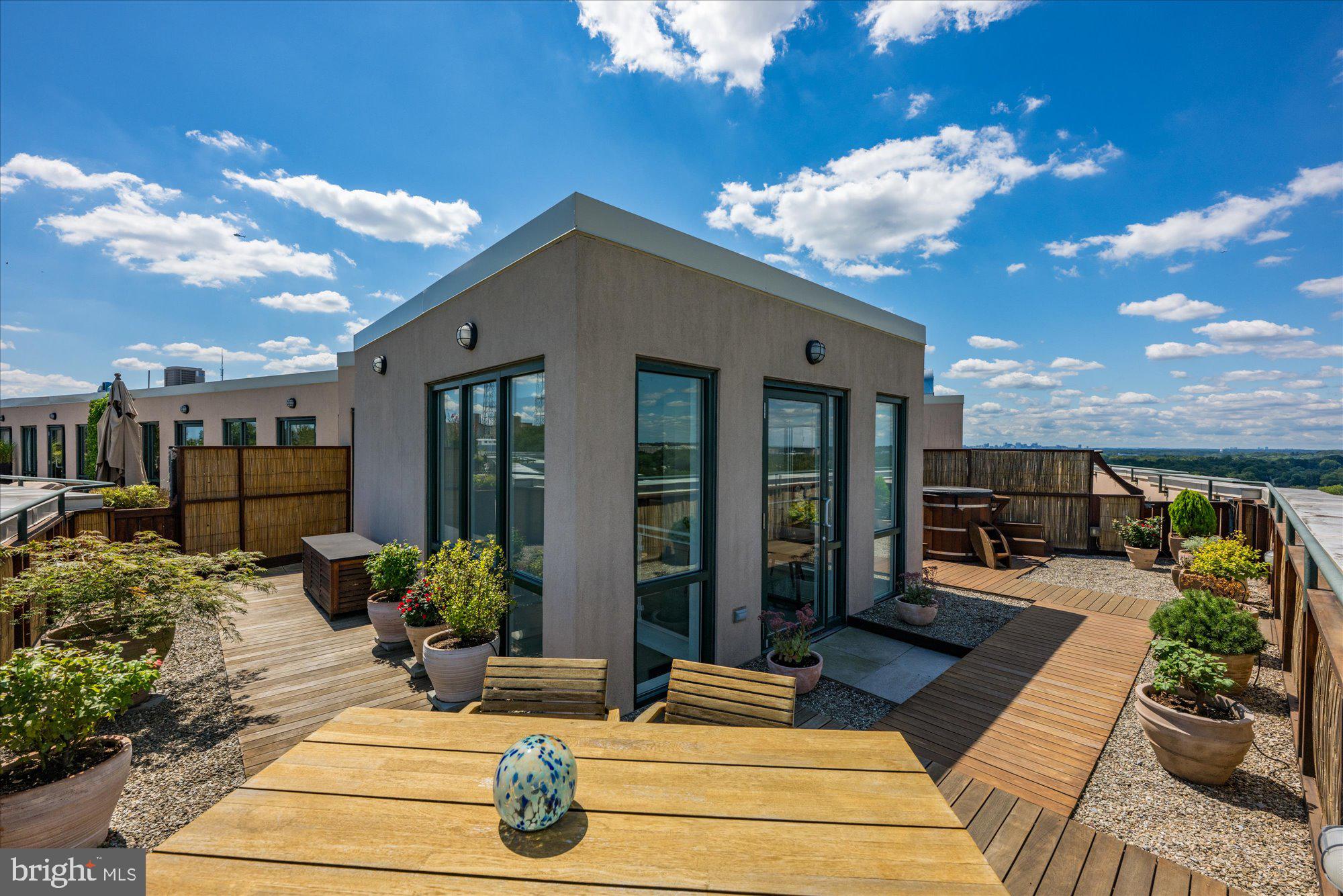 4750 41st Street Northwest, Unit 507 Washington, DC 20016 - Photo 43 of 50 a view of a patio with couches table and chairs under an umbrella