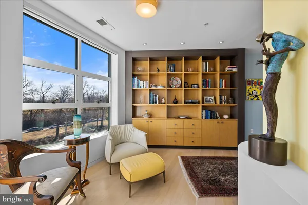 a living room with furniture and a book shelf