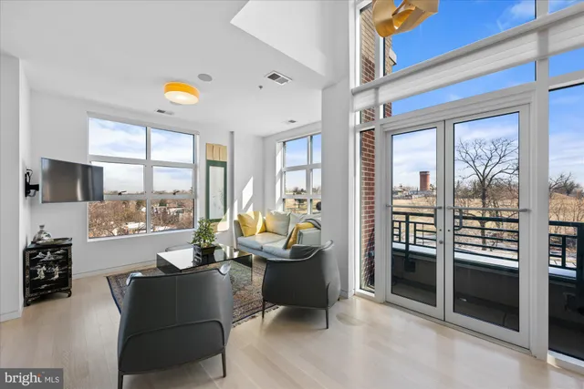 a living room with furniture and a floor to ceiling window