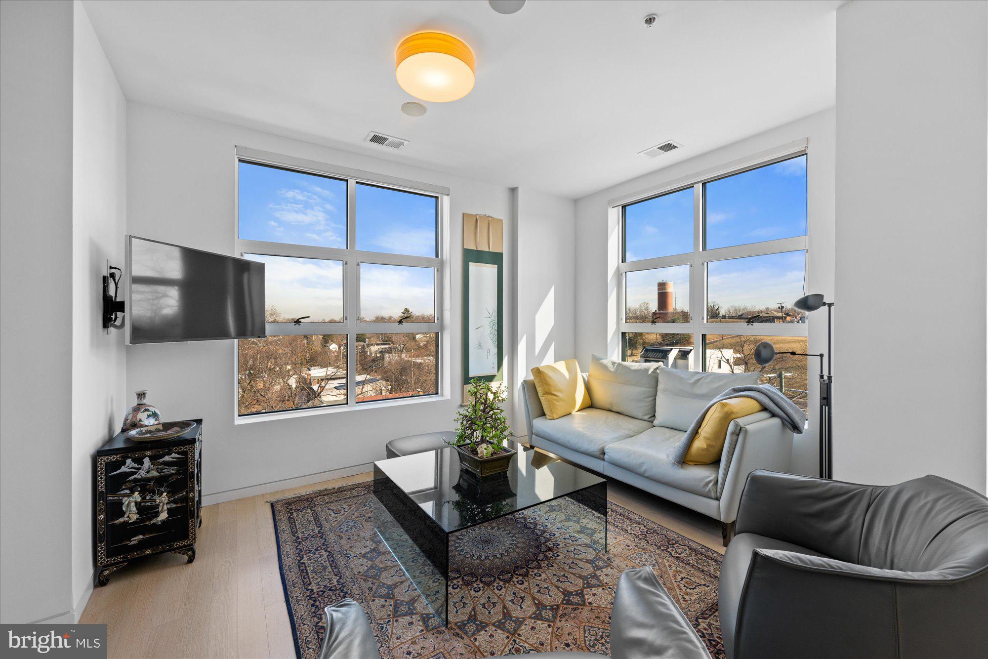4750 41st Street Northwest, Unit 507 Washington, DC 20016 - Photo 9 of 50 a living room with furniture and a flat screen tv