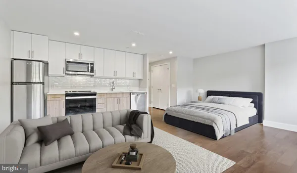 a kitchen with stainless steel appliances granite countertop a refrigerator and microwave