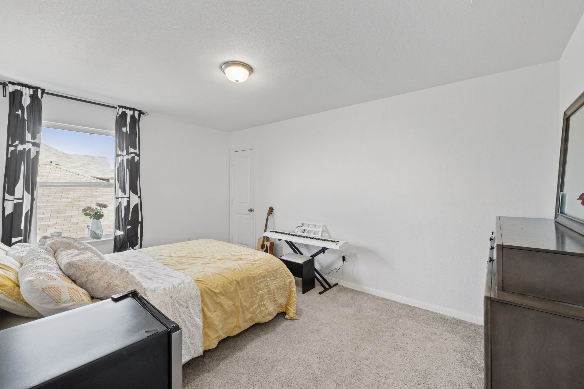 189 Durian Loop Buda, TX 78610 - Photo 24 of 38 Bedroom featuring baseboards and light carpet