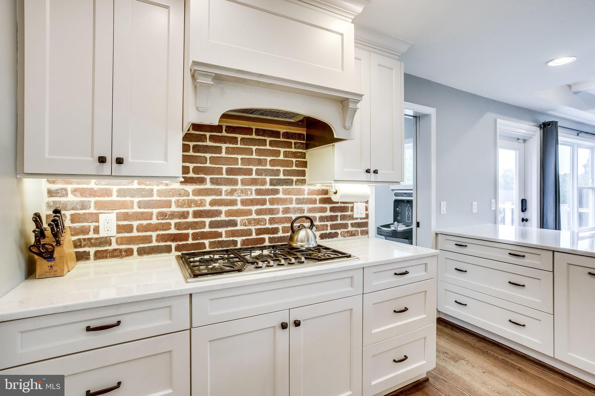 1211 Bishopsgate Way Reston, VA 20194 - Photo 11 of 56 5 burner cooktop and brick accent backsplash