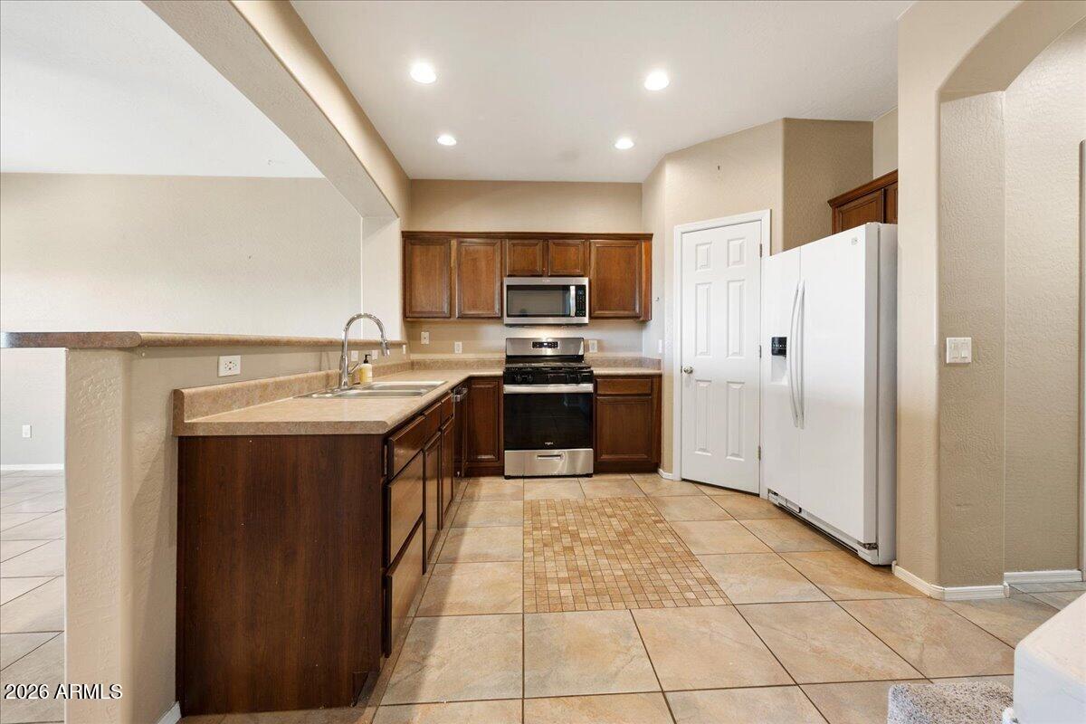813 Alfonse Road Clarkdale, AZ 86324 - Photo 23 of 41 a large kitchen with stainless steel appliances granite countertop a sink and cabinets