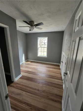 a view of a hallway view with wooden floor and staircase