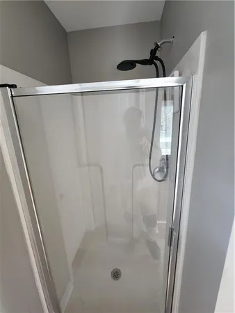 a bathroom with a bathtub and next to a window