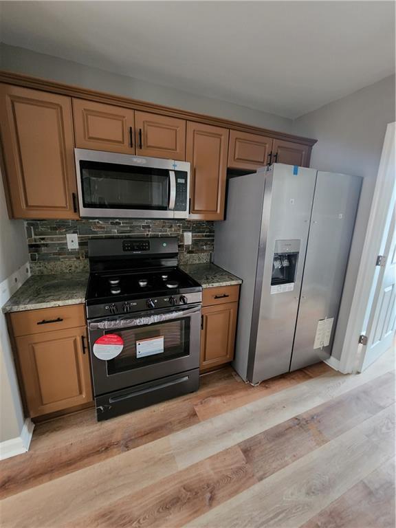 300 Overland Trail Temple, GA 30179 - Photo 32 of 35 a kitchen with stainless steel appliances a stove a microwave and a refrigerator