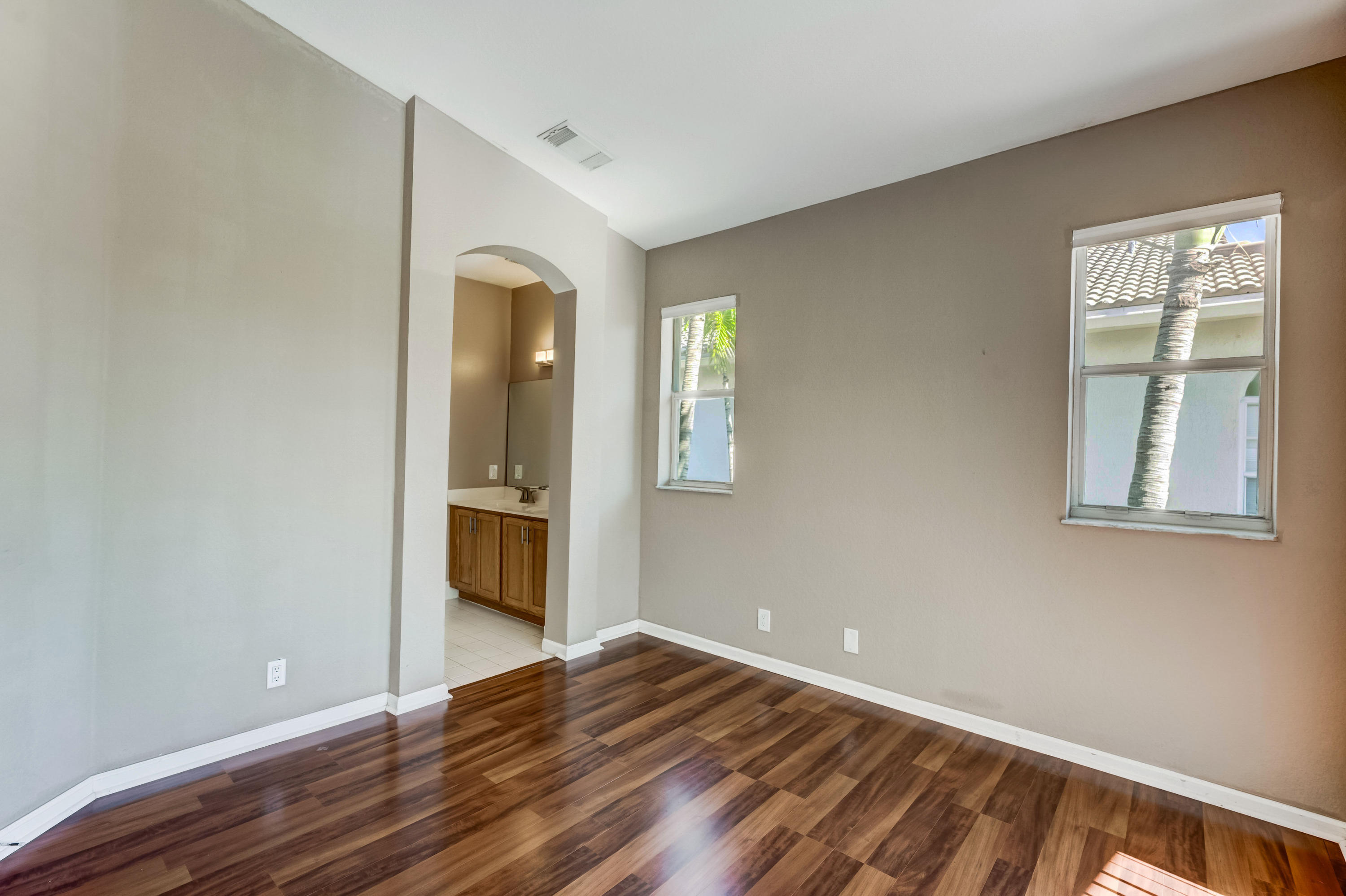 3174 Laurel Ridge Circle Riviera Beach, FL 33404 - Photo 8 of 32 a view of an empty room with wooden floor and a window