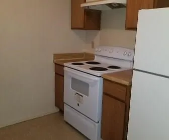 a stove top oven sitting inside of a kitchen