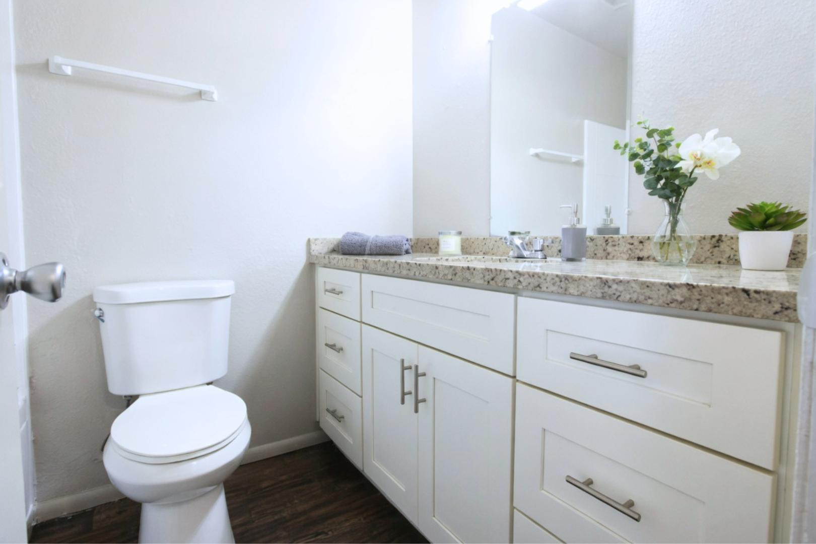 9230 North 6th Street, Unit 9 Phoenix, AZ 85020 - Photo 2 of 7 a bathroom with a granite countertop toilet sink and mirror