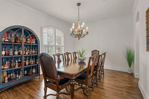 a view of a dining room with furniture a rug and wooden floor