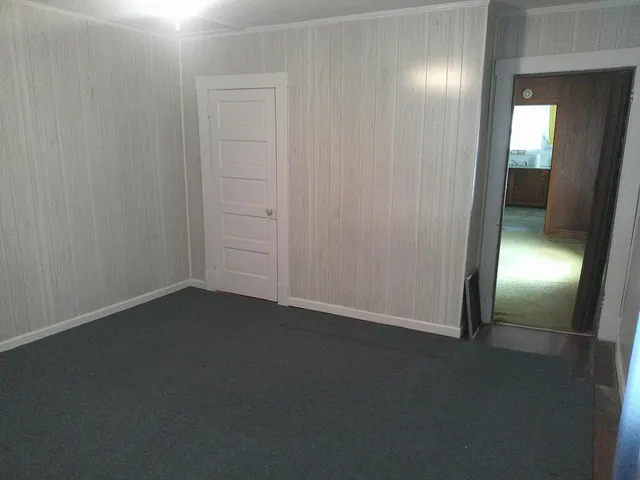an empty room with closet area