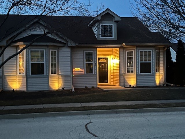 12242 Quail Ridge Drive Huntley, IL 60142 - Photo 2 of 13 a view of a house with large windows and a yard