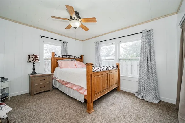 a bed sitting in a room next to a window