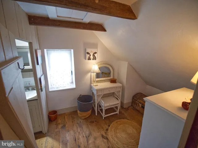 a room with furniture a rug and a window