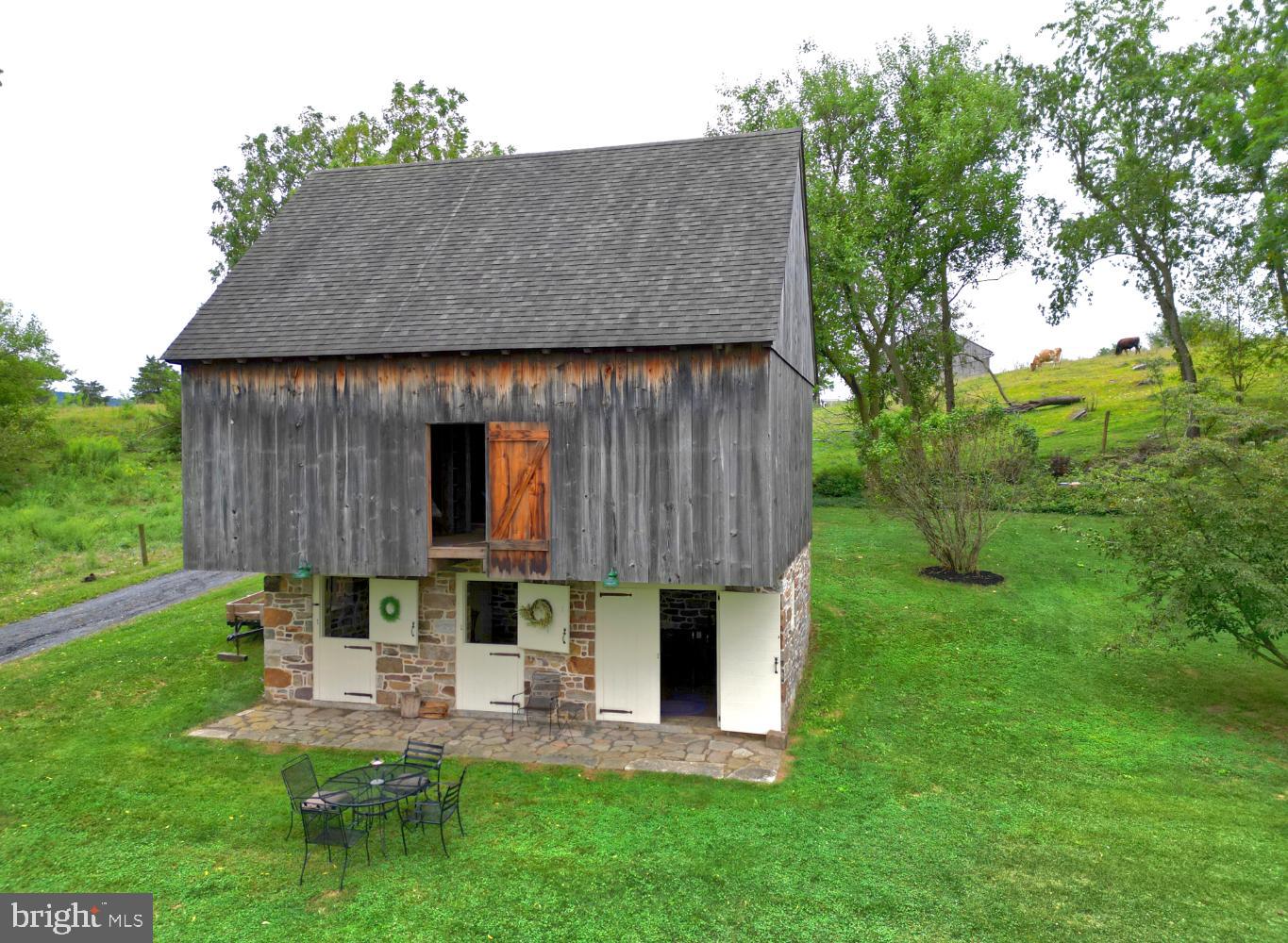 784 Coffee Run Road Reedsville, PA 17084 - Photo 28 of 48 a view of a table and chairs in backyard of the house