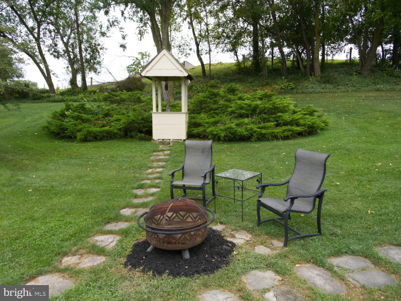 784 Coffee Run Road Reedsville, PA 17084 - Photo 42 of 48 a view of a backyard with table and chairs potted plants and a large tree