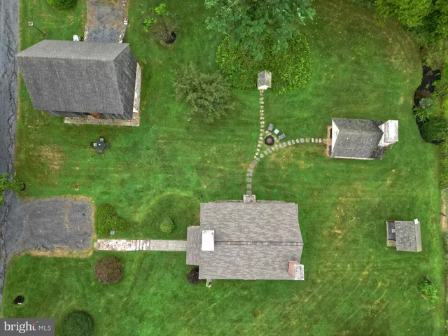 an aerial view of a house with a yard