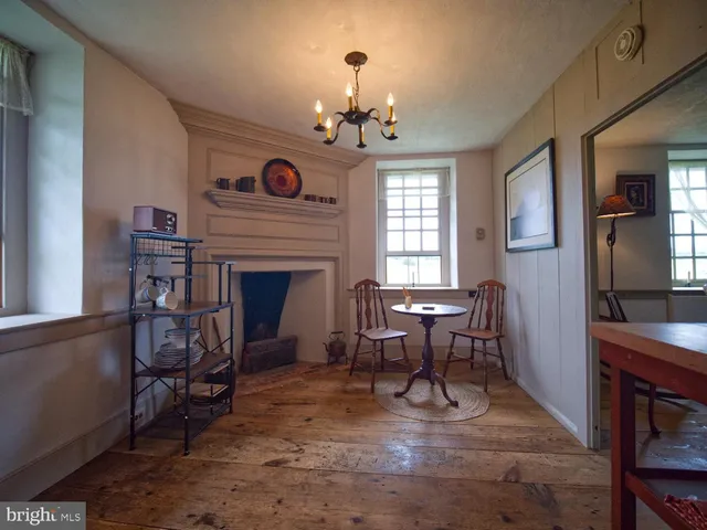 a view of a dining room with furniture a chandelier and wooden floor