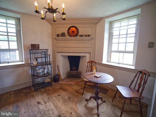 a living room with furniture a window and a fireplace