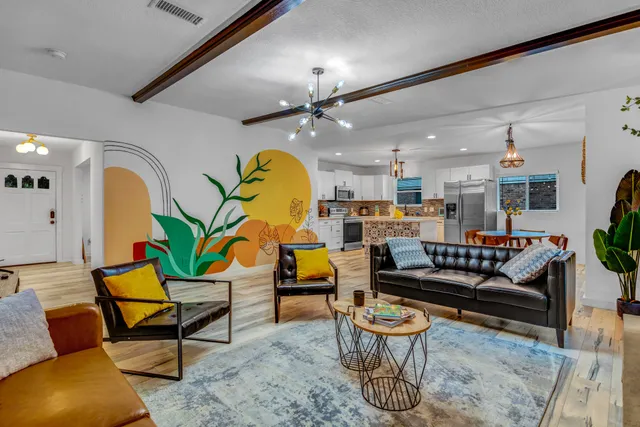 a living room with furniture and kitchen view