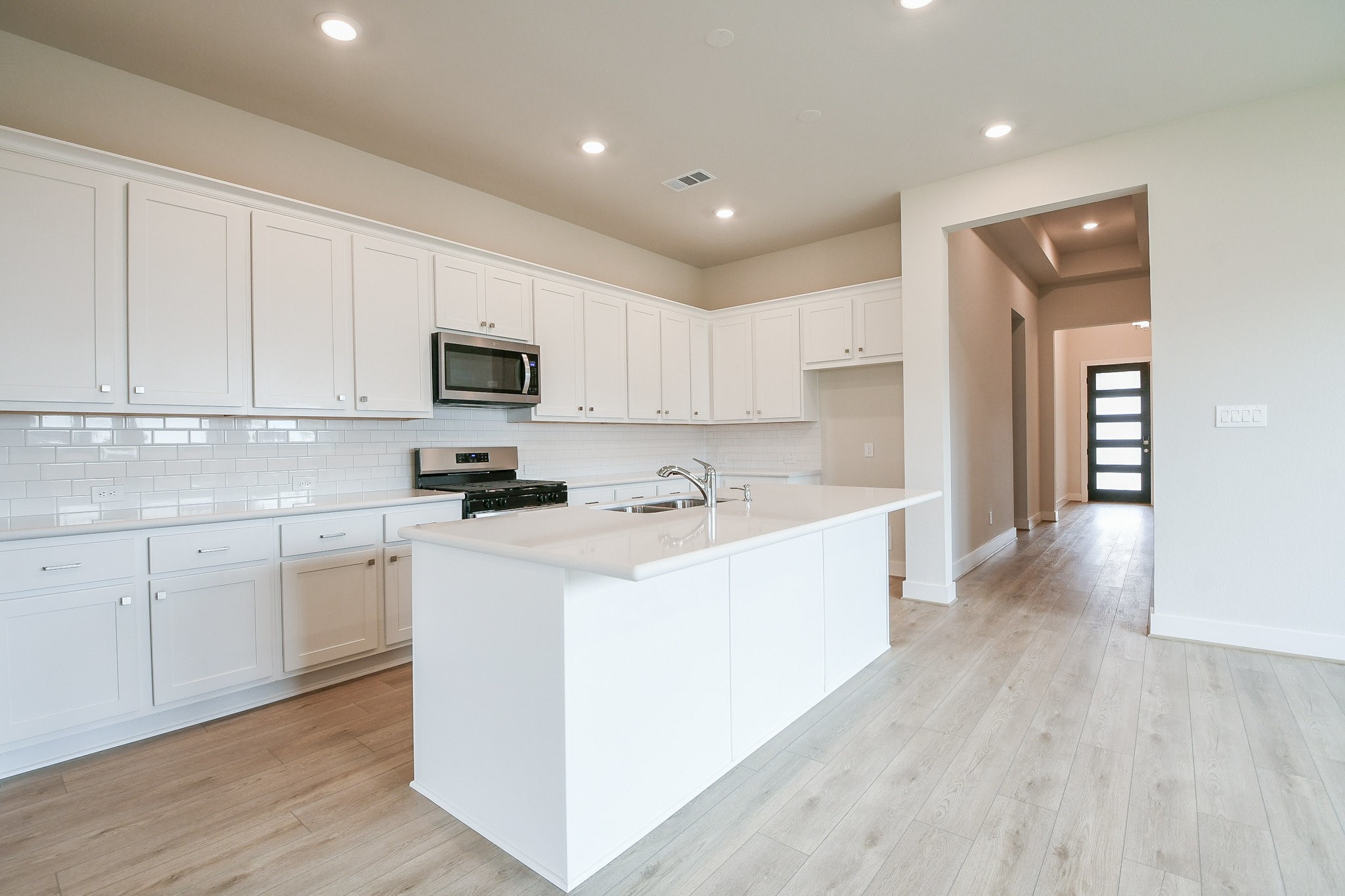 5005 Vly Wind Court Spring, TX 77386 - Photo 14 of 20 a kitchen with sink a microwave and cabinets