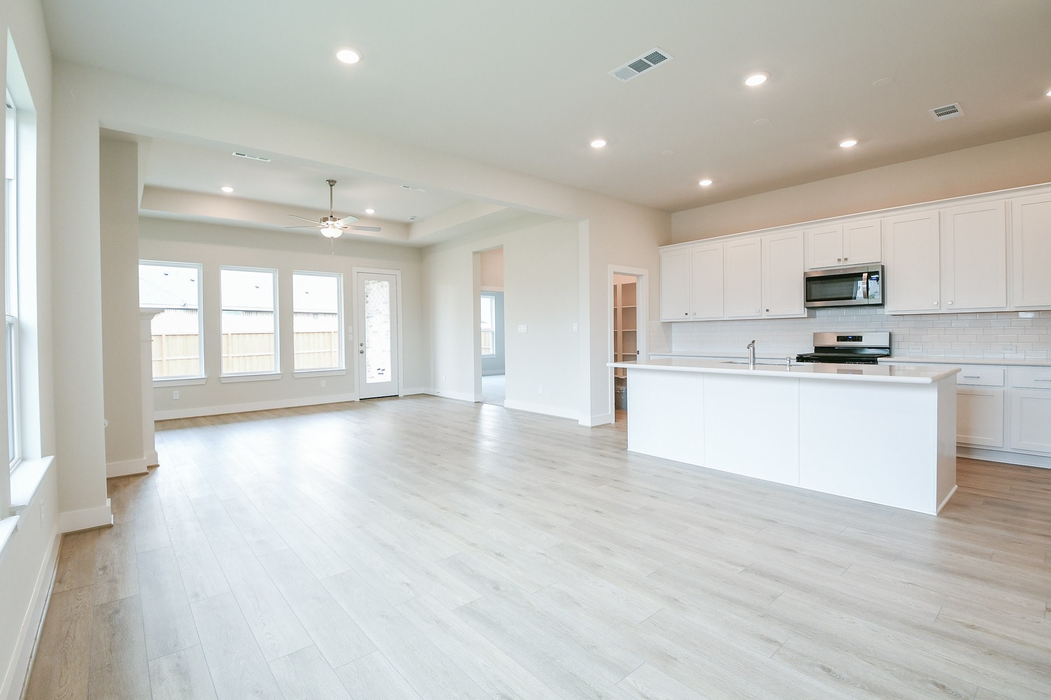 5005 Vly Wind Court Spring, TX 77386 - Photo 17 of 20 a view of kitchen with cabinets and wooden floor