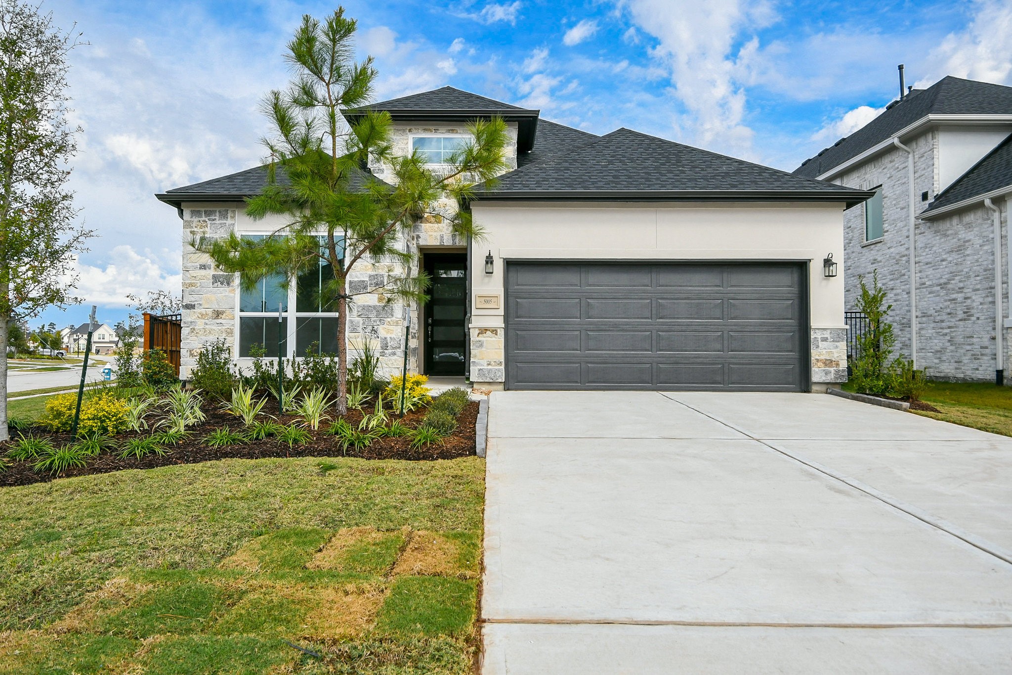 5005 Vly Wind Court Spring, TX 77386 - Photo 2 of 20 a front view of yellow house with a yard