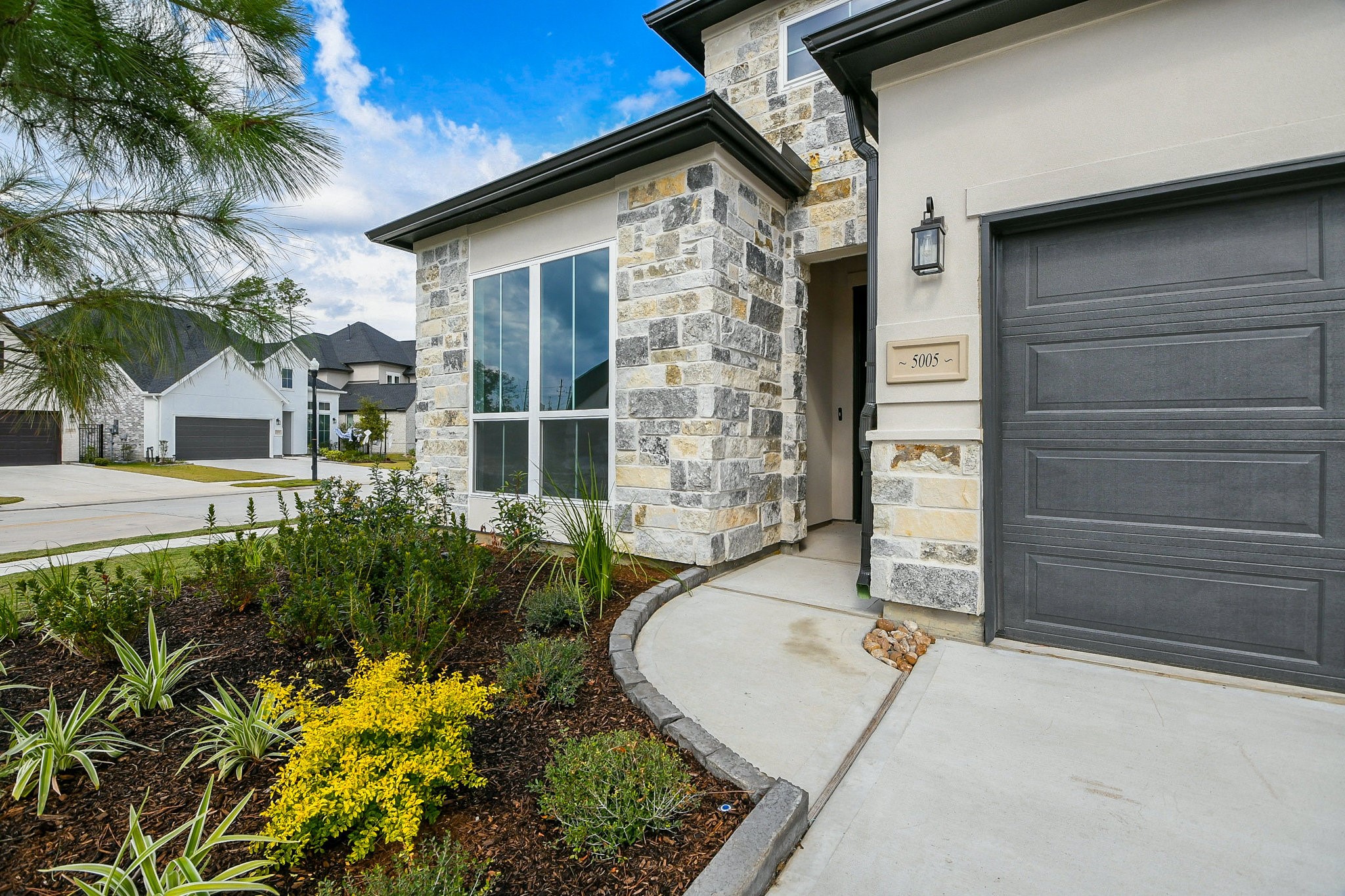 5005 Vly Wind Court Spring, TX 77386 - Photo 3 of 20 a front view of a house with a garden