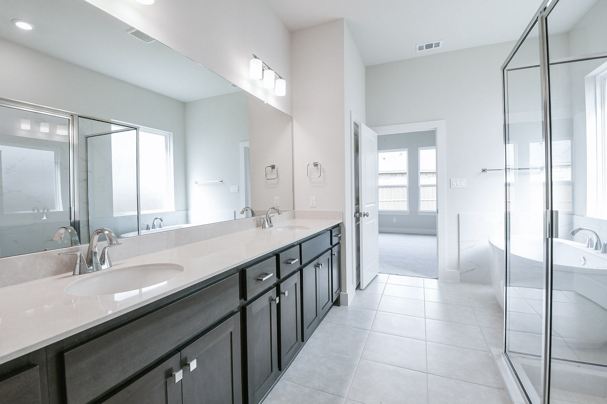 5005 Vly Wind Court Spring, TX 77386 - Photo 7 of 20 a spacious bathroom with a double vanity sink a mirror and a bathtub