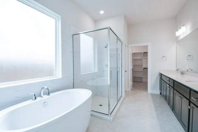 a spacious bathroom with a double vanity sink and a mirror