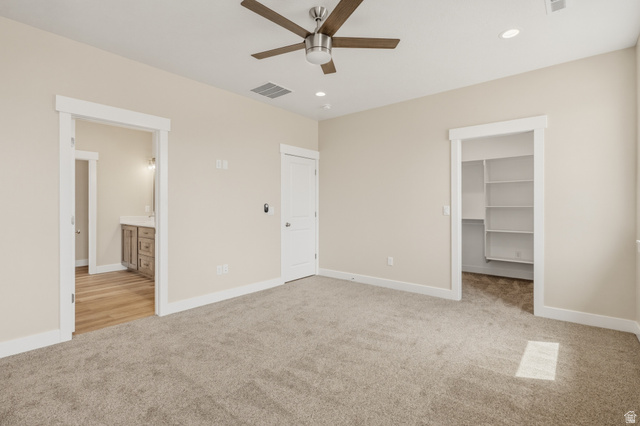 157 West 100 South Joseph, UT 84739 - Photo 13 of 30 Unfurnished bedroom featuring light colored carpet, a walk in closet, recessed lighting, connected bathroom, and a ceiling fan