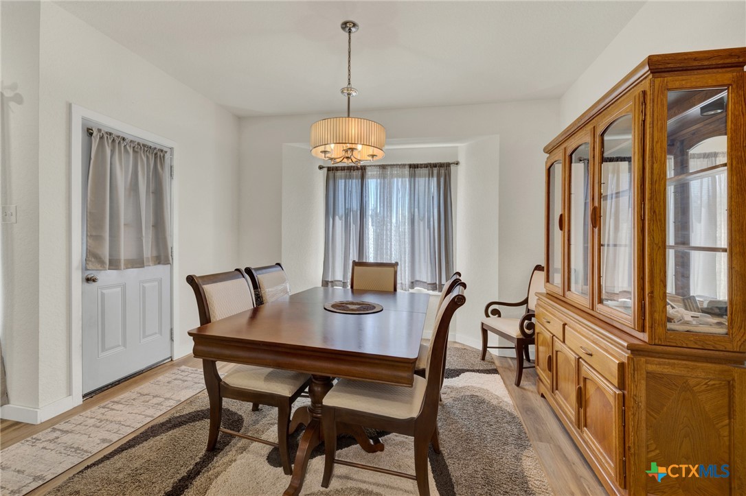 305 Lake Crest Spring Branch, TX 78070 - Photo 7 of 38 a view of a dining room with furniture window and wooden floor