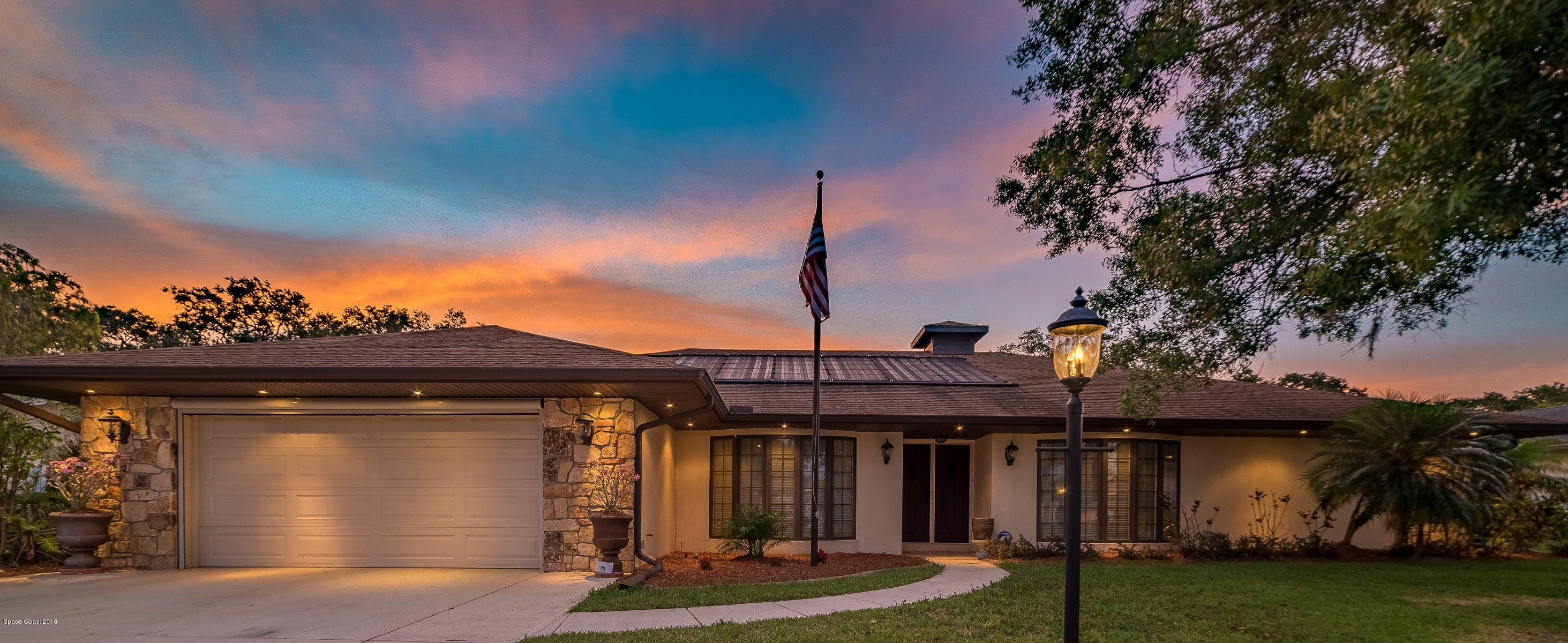 1401 Meadowbrook Road Northeast Palm Bay, FL 32905 - Photo 2 of 46 a front view of a house with garden