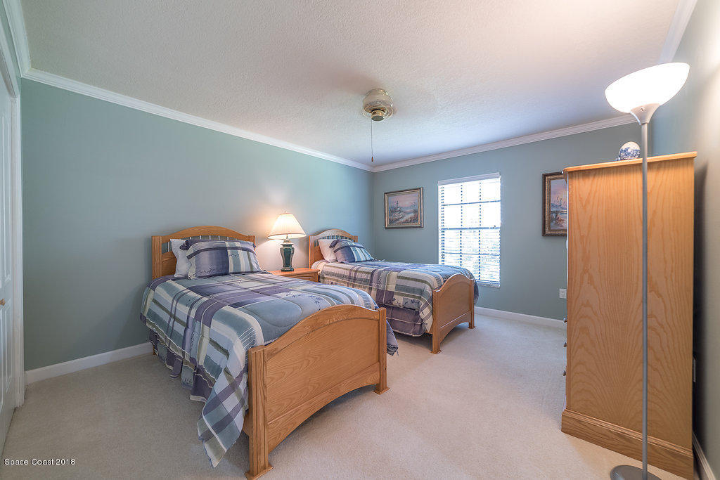 1401 Meadowbrook Road Northeast Palm Bay, FL 32905 - Photo 11 of 46 a bedroom with bed and window