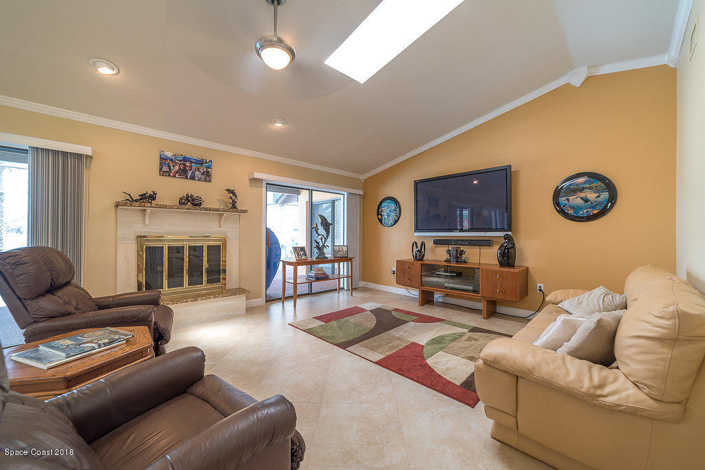 1401 Meadowbrook Road Northeast Palm Bay, FL 32905 - Photo 12 of 46 a living room with furniture kitchen view and a window